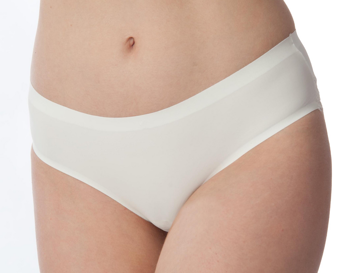 Close-up of a model wearing white high-waisted briefs against a plain white background.