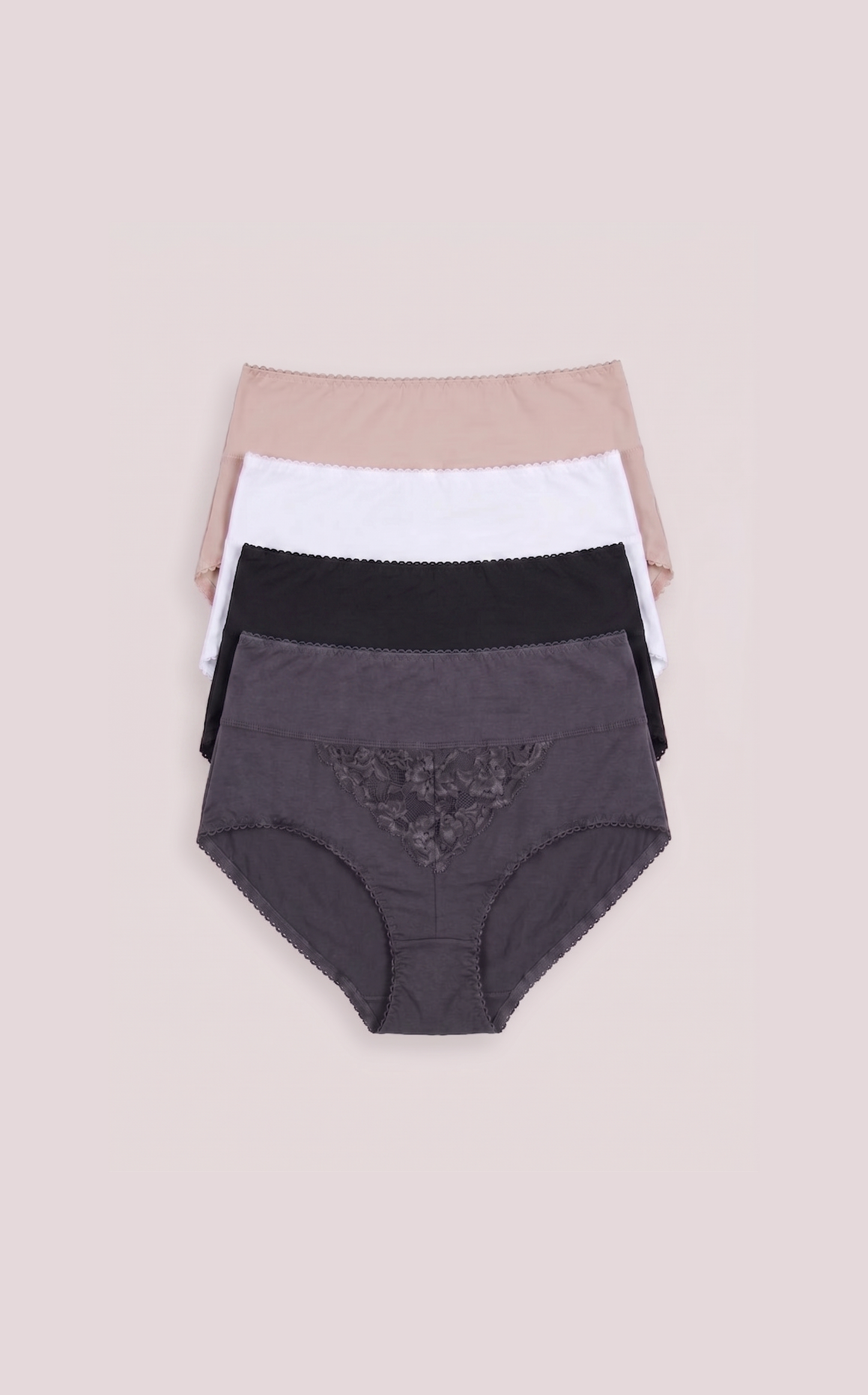 Three pairs of women's underwear in black, white, and beige on a beige background
