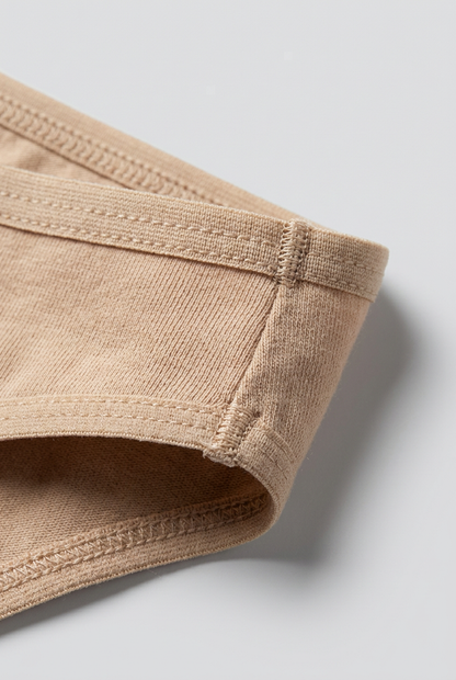 Close-up of beige shorts on a light gray background